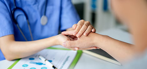 doctor holding patient's hand